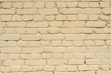 Closeup backgrounds texture of yellow beige painted retro brick wall.