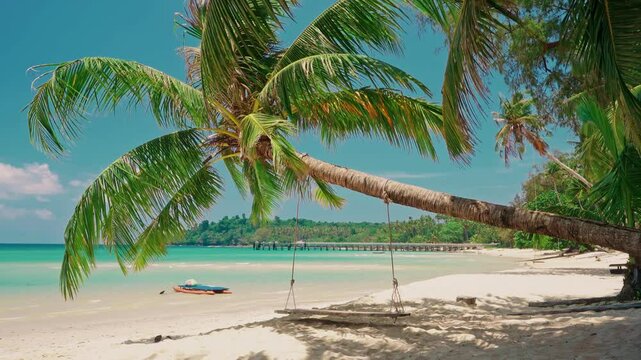 Tropical beach with palm tree and silhouette travel people on kayak in ocean on background colorful sunset. Summer holidays in tropical paradise concept