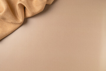 Brown fabric on beige as concept background. Copy space