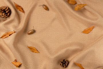 Brown fabric with leaves as concept background. Copy space