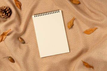 Empty notebook on fabric background from above. Flat lay, top view.