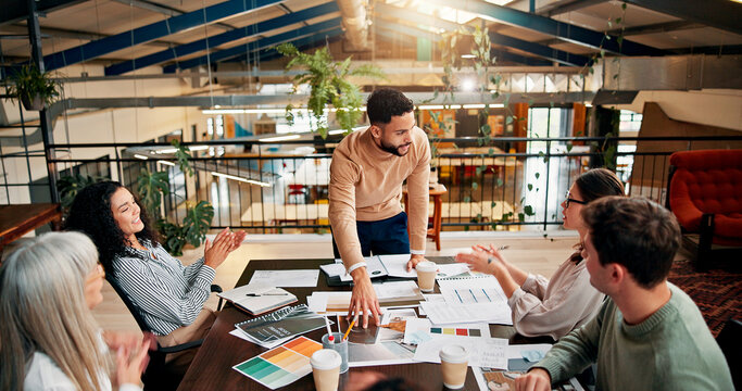 Creative paperwork, people and applause in meeting for campaign performance, KPI goals and branding success. Design agency, employees and clapping hands for marketing pitch approval and achievement