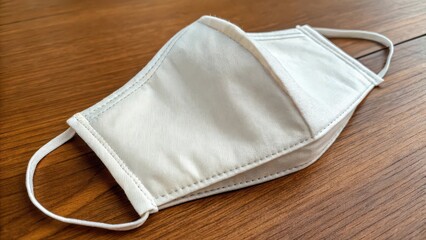 Close up of a white fabric face mask lying mockup