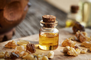 A bottle of frankincense essential oil with frankincense resin