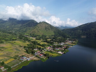 Aerial view of a peaceful lakeside village in Samosir, located on Lake Toba, North Sumatra,...