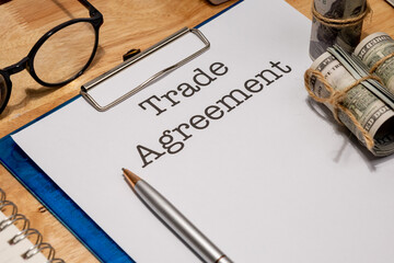 A financial trade agreement paper rests on a desk, symbolizing economic negotiations and international cooperation.