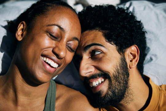 Happy man enjoying leisure time with girlfriend at home