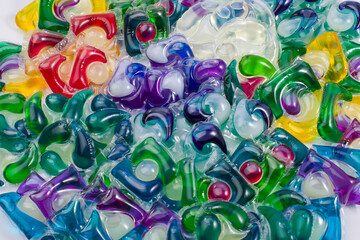 Background of multicolored washing gel capsules. Top view.
