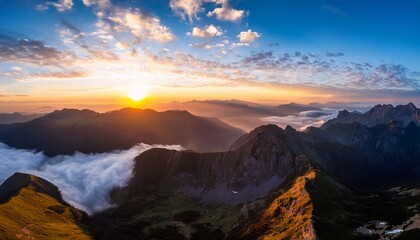 wide angle aerial view of vast landscape at sunrise with vibrant clouds and warm golden light on mountains and valleys