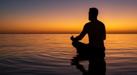Fototapeta premium Silhouette of a man meditating in the sea during sunset, serene mindfulness practice, peaceful reflection in the water