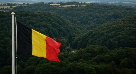 Waving Belgian Flag Representing National Unity Amidst the Dense Rolling Forests of the Ardennes