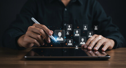 Person using tablet with stylus to select from multiple profile icons in a digital interface setting