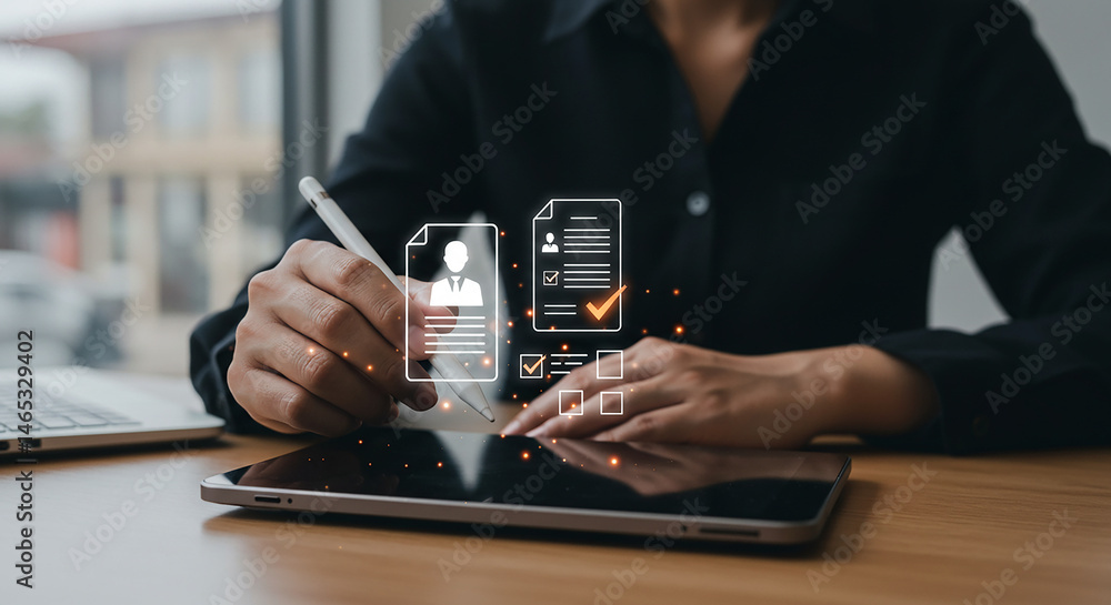 Aufkleber person using tablet with stylus to fill out digital forms with laptop in the background on desk