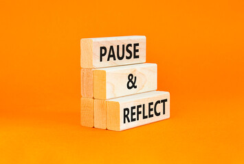 Pause and reflect symbol. Concept words Pause and reflect on beautiful block. Beautiful orange...