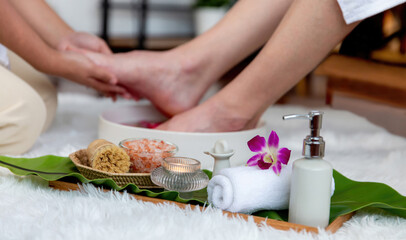 Man indulges in blissful foot massage at luxurious spa salon while masseur give reflexology therapy...