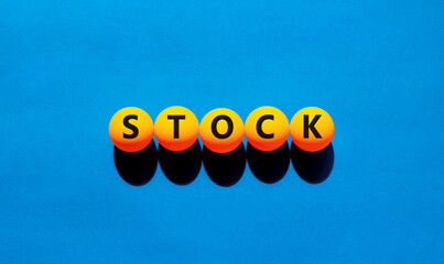 Stock symbol. Concept word Stock on beautiful yellow tennis ping pong balls. Beautiful wooden table...