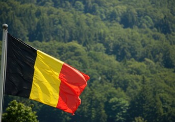 Waving Belgian Flag Representing National Unity Amidst the Dense Rolling Forests of the Ardennes