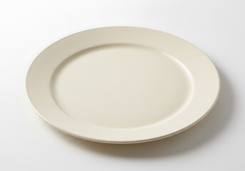 An overhead shot of a plain off white plate centered on a white background with soft shadows around it