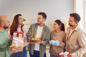 Happy birthday candle cake, presents celebration, friendly group family portrait, young friends party together for special event. Smiling people gathering making fun and enjoy wishing great happiness