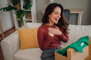 Happy woman receiving surprise gift feeling gratitude at home
