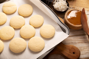 Fototapeta premium Cookies for making Alfajores. A traditional dessert popular in Latin America, it consists of two cookies sandwiched together with dulce de leche, topped with powdered sugar or shredded coconut.