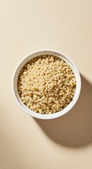 Plain Quinoa in White Bowl on Beige Background
