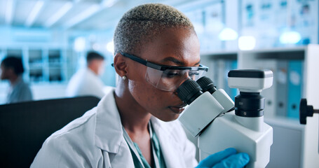 Science, microscope and research with woman in laboratory for testing, gene editing and healthcare...