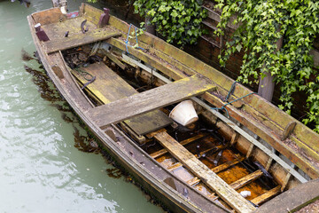 Abandoned Wooden Boat with Ivy Wall