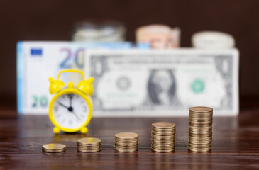 Gold money coins and euro dollar bills in the background. Currencies exchange rate concept.