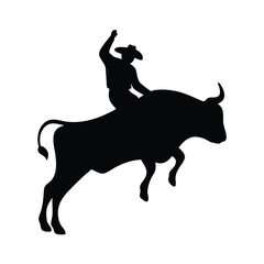 Silhouette of a cowboy riding a bucking bull in a rodeo competition