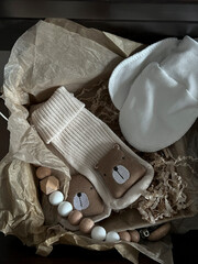 Socks, white scratches, a rodent elephant, beads. A set of accessories and toys for newborns in a...