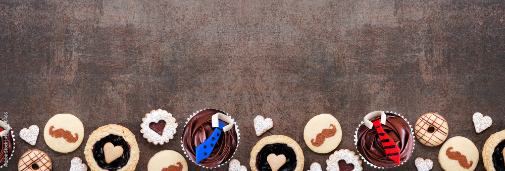 Poster fathers day themed baking bottom border with a collection of cookies and sweet treats. top view on a