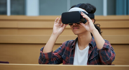 Young asian male using vr headset in classroom setting for educational experience