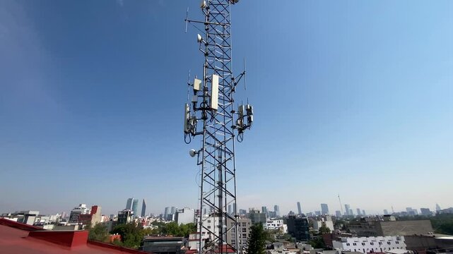 4G and 5G internet telecommunications antennas are seen on the top of a building in Roma district, Mexico City, Mexico. Reforma avenue skyscrapers are seen in the background.