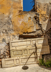 old door panels blokking the entrance of an abandoned house in Gythio, Greece