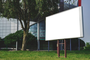 Billboard mockup on the background of a glass building in the city.