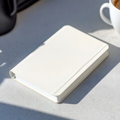 Fototapeta premium Blank White Notebook Mockup on Table Sunlit