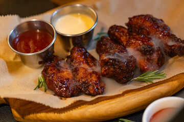 Closeup of chicken wings with dips served at restaurant
