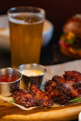 Closeup of chicken wings with dips served at restaurant