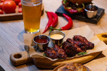 Closeup of chicken wings with dips served at restaurant