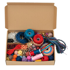 A cardboard box filled with various craft supplies, beads, and colorful threads ready for crafting.