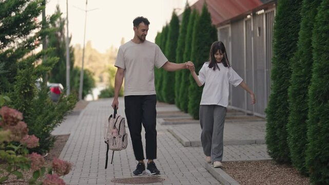 This heartwarming video captures a special moment between a father and his daughter as they walk home from school together after class, enjoying each other's presence.