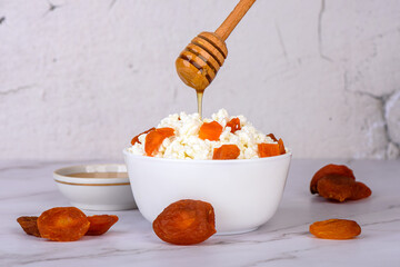 Fresh cottage cheese with dried apricots poured with honey.