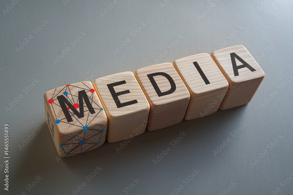 Poster wooden cubes spelling media, first cube shows network concept, signifying digital communication and 