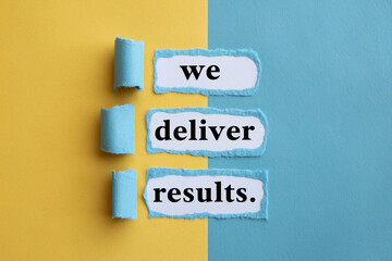 Torn blue paper reveals text: "we deliver results" on yellow and blue background, showcasing business success and achievement