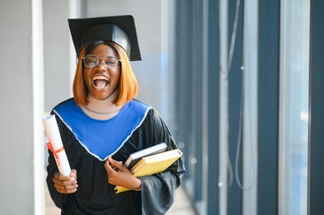 beautiful young afro american graduate holding diploma