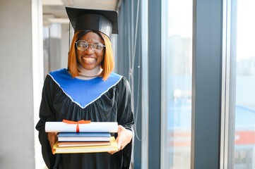 beautiful young afro american graduate holding diploma
