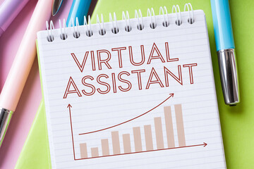 Notebook with "Virtual Assistant" text and upward trending graph, showcasing business growth and virtual assistance services