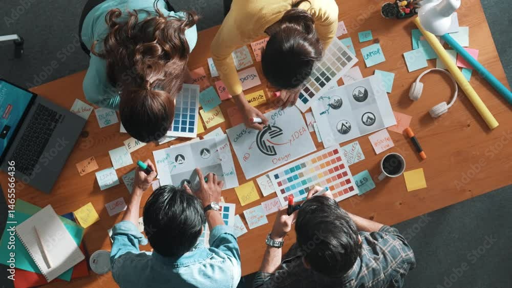 Aufkleber top view of business team write graphic logo on meeting table with colorful sticky notes and design 
