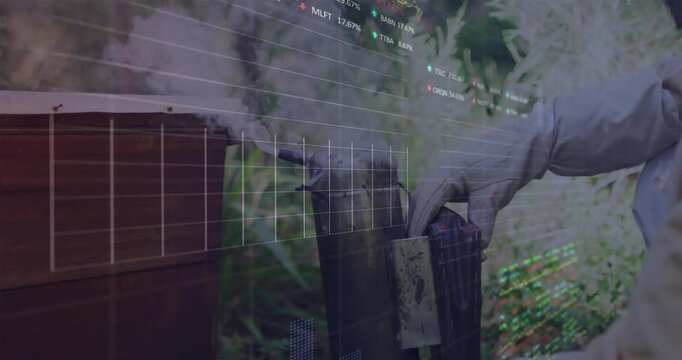 Male beekeeper holding bee smoker in garden, displaying live stock market graphs and tickers - Powered by Adobe